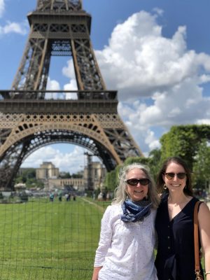 A photo of Mrs. Katie Eissler-Thiel and Madame Cooper in front of the Tour Effiel during the 2020 French Summer Exchange Program