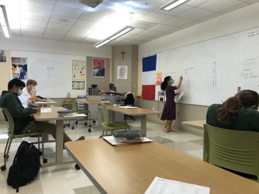 Madame Horning, who previously taught at Mount Pleasant High School, demonstrates verb conjugation to her socially-distanced French II students at Archmere. 