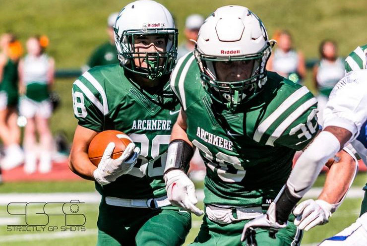 Declan Pearson sets up a block for Johnny Kim as Archmere marches down the field. Photo taken by Gee Johnson.