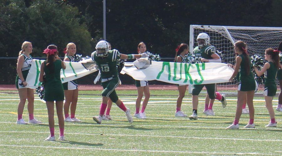Conor Udovich runs through the banner on Homecoming against Tower Hill. 