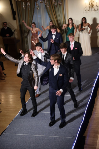 Senior Boys dance down the runway wearing Matthews Formal wear.